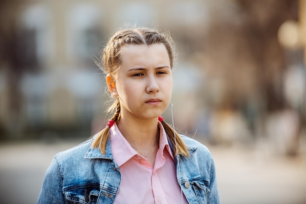 Portrait of a girl with headphones in the city