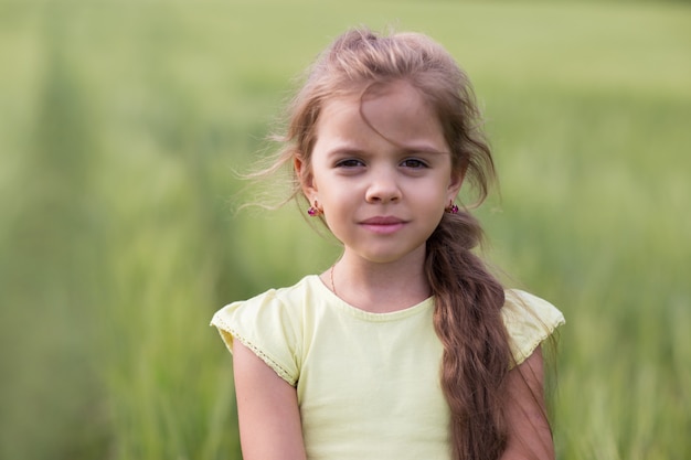 Portrait of a girl with long hair in a field