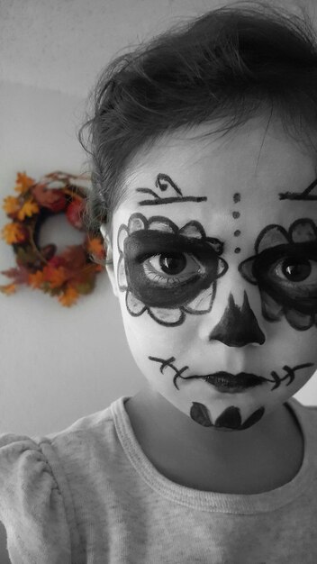 Photo portrait of girl with painted face at home