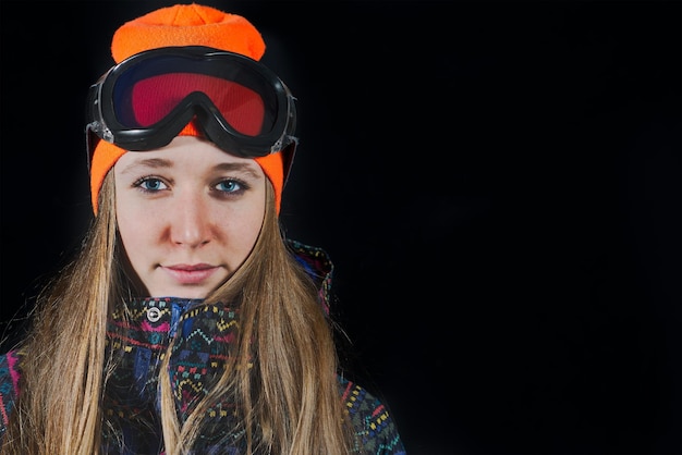 Portrait of girl with ski mask and snowboard