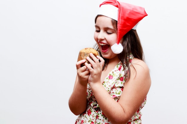 Portrait of girl with small panetone, white background