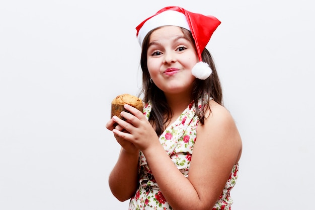 Portrait of girl with small panetone, white background