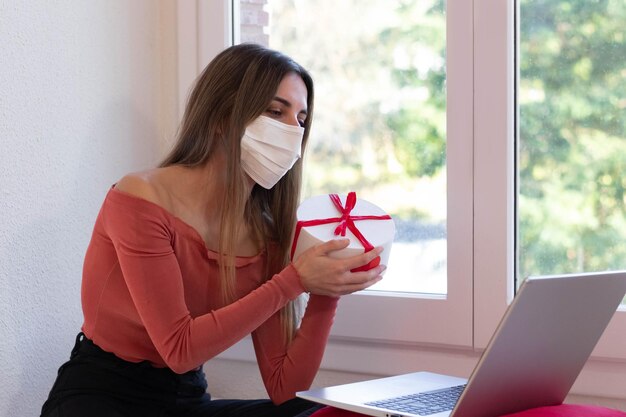 Portrait of a girlfriend giving her boyfriend a gift for his anniversary