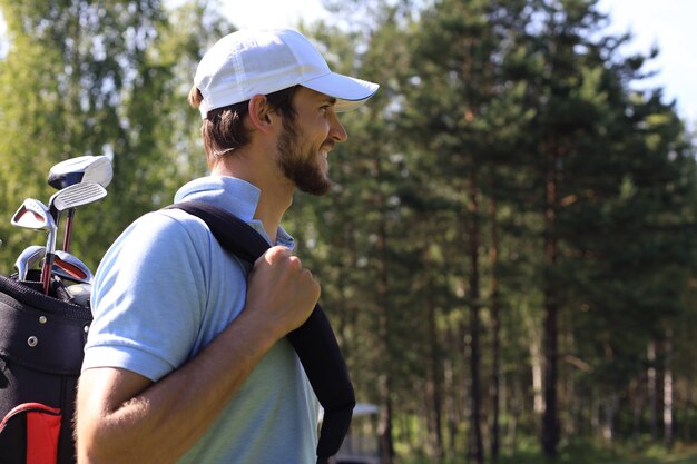 Portrait Golf man walking with shoulder bag.