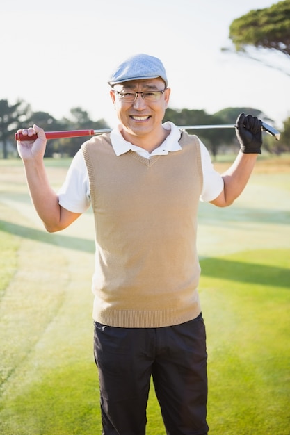 Portrait of golfer smiling and holding his golf club