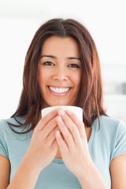 Portrait of a good looking woman enjoying a cup of coffee