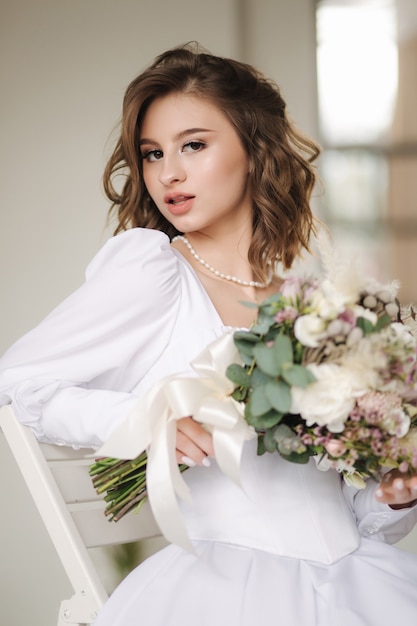 Portrait of gorgeous bride in sudio close up of elegant female posing to photographer woman hold