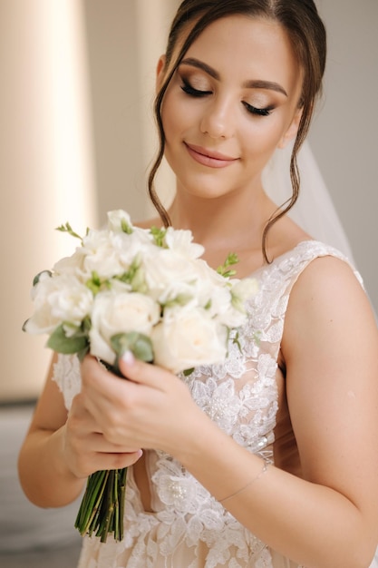 Portrait of gorgeous bride with beautiful wedding bouquet morning of bride wedding day