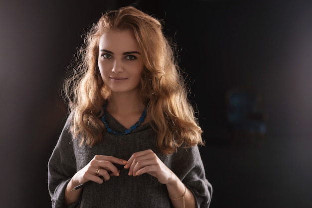 Photo portrait of a gorgeous female artist working on art project on her studio