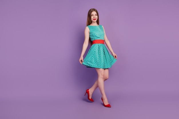 Portrait of gorgeous lady walk hold short skirt wear mini dress high-heels on purple background