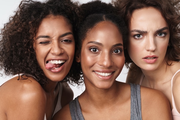 Portrait of gorgeous multiracial women standing together and looking at camera 