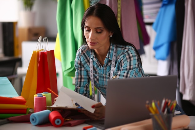 Portrait of gorgeous woman sitting at comfortable workplace