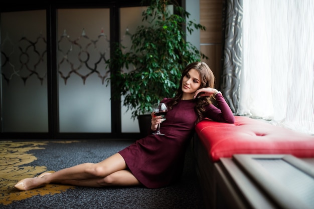 Portrait of a gorgeous young brunette woman having wine fun.