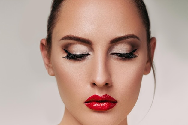 Portrait of gorgeous young brunette woman with red lips