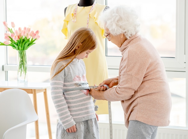 Portrait of grandmother and granddaughter in an atelier