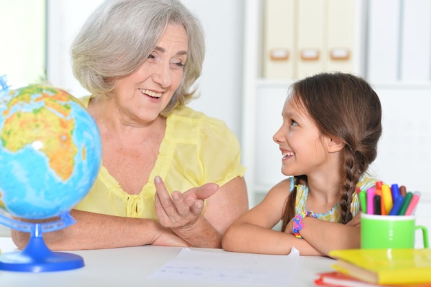 Portrait of grandmother and granddaughter studying together