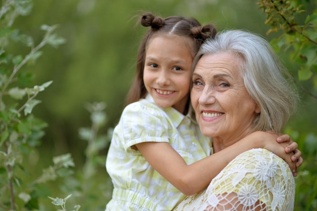 Portrait of grandmother and granddaughter in summer park