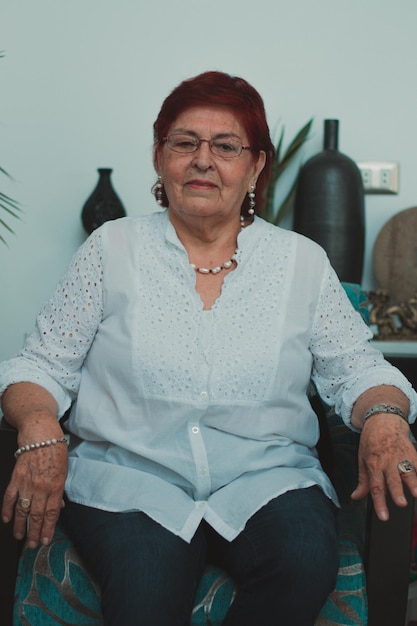 Portrait of a grandmother sitting on the couch in the living room