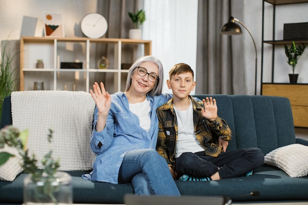 Portrait of a grandmother with her grandson an old woman sits on the sofa