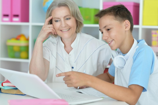 Portrait of a granny with her grandson using laptop