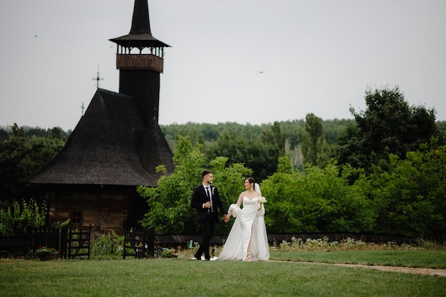 Portrait groom and bride on the background at the church