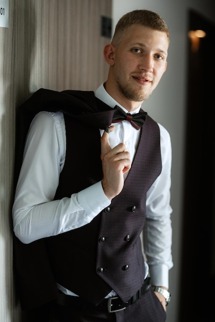 Portrait of the groom in a brown threepiece suit