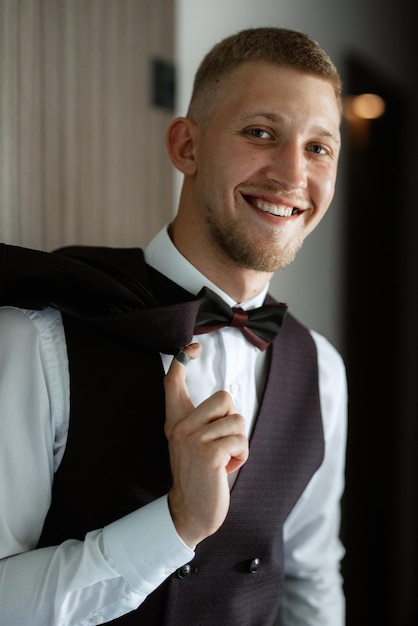 Portrait of the groom in a brown threepiece suit