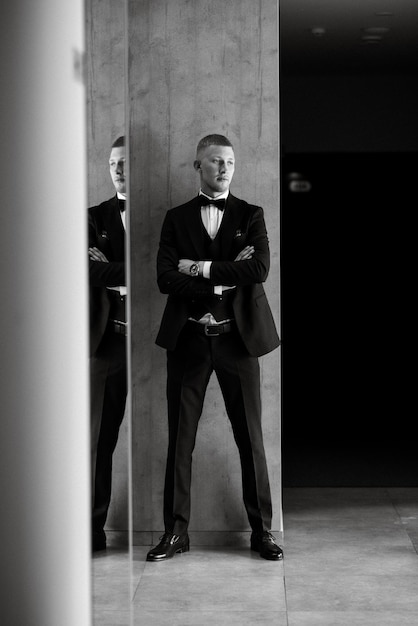 Portrait of the groom in a brown threepiece suit