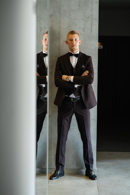 Portrait of the groom in a brown threepiece suit