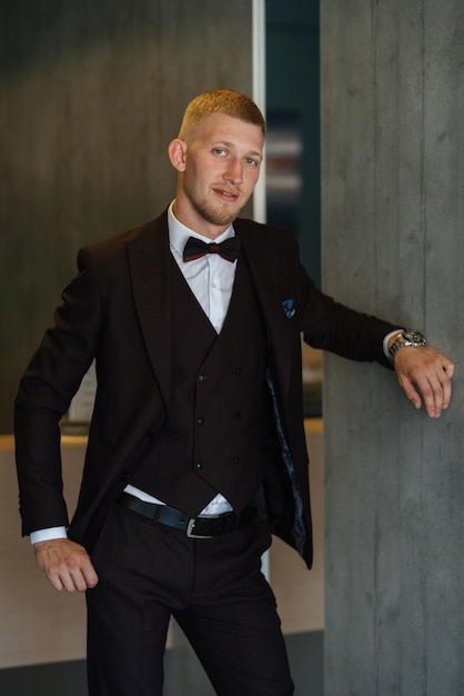 Portrait of the groom in a brown threepiece suit