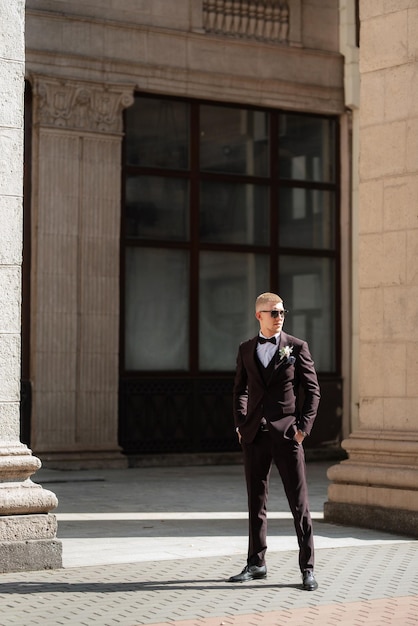 Portrait of the groom in a brown threepiece suit