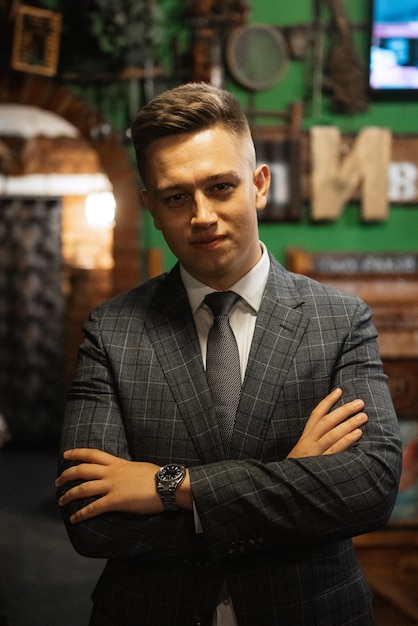 Portrait of a groom in a gray plaid suit with a tie