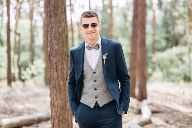 Portrait of a groom posing in nature