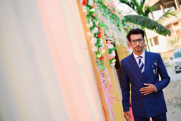 Photo portrait of groom in suit during wedding ceremony
