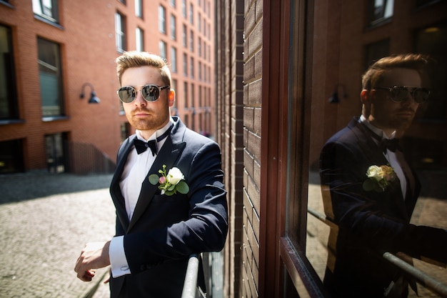 Portrait of a groom, walking in the city. Wedding day, marriage . Bride and groom in urban .