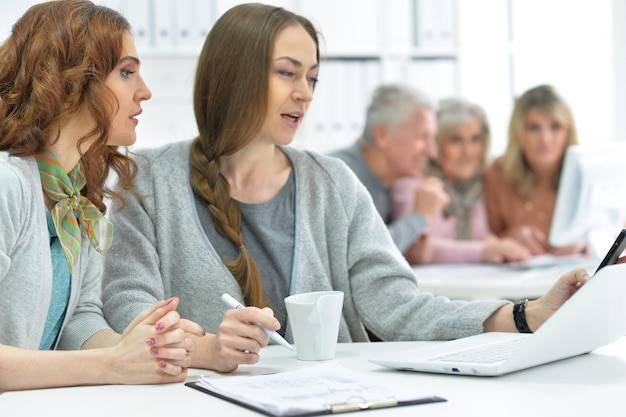 Portrait of group of active business people working