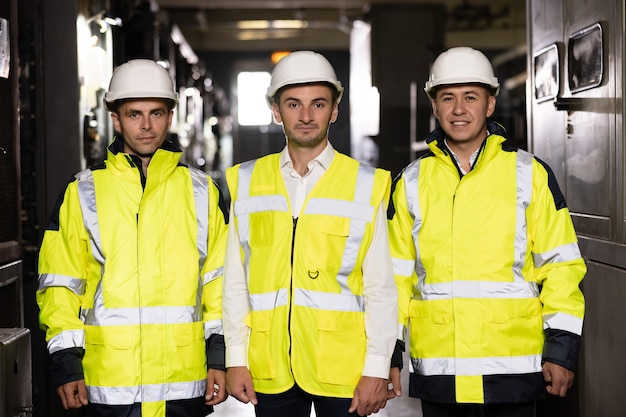 Portrait of group of professional telecommunication industry engineers smiles and looks at the camer