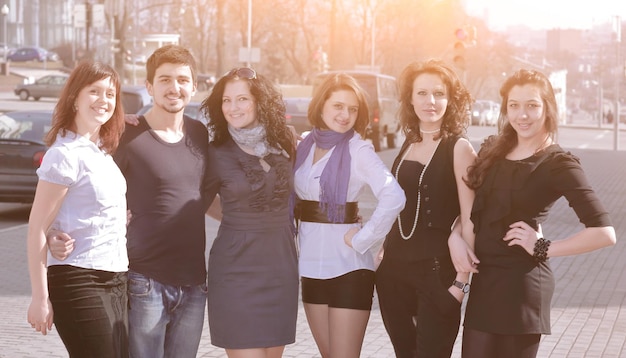 Portrait of a group of students standing on a city street