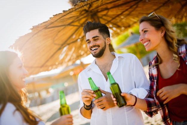 Portrait of group of young friends having a party on the beach