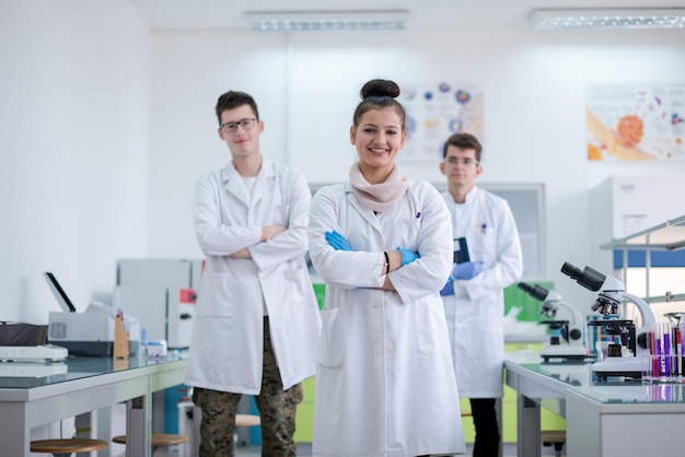 portrait of a group young medical students standing together in chemistry laboratory,teamwork by college student indoors