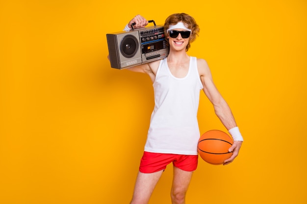 Portrait guy holding in hands carrying boombox basketball ball