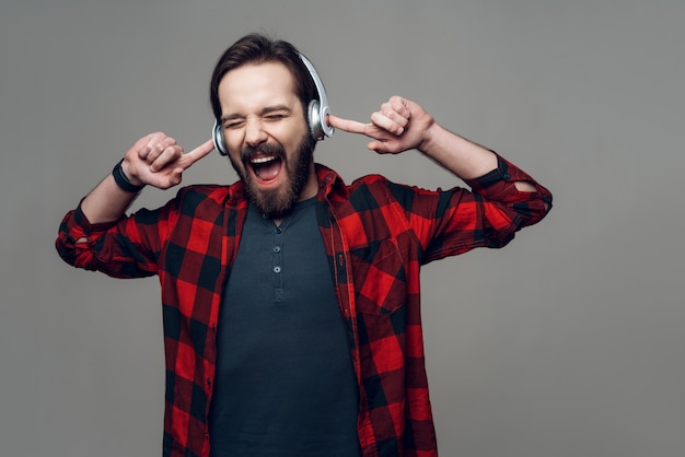 Portrait of guy listening to music with headphones