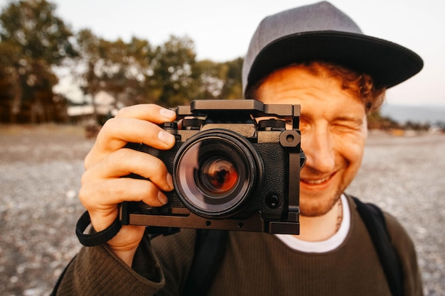 Portrait of a guy taking a photo with a professional camera