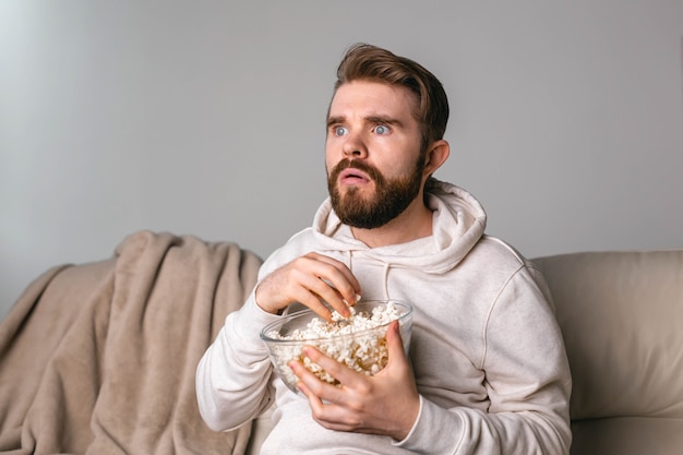 Portrait of guy watching tv series online online cinema and video streaming service concept