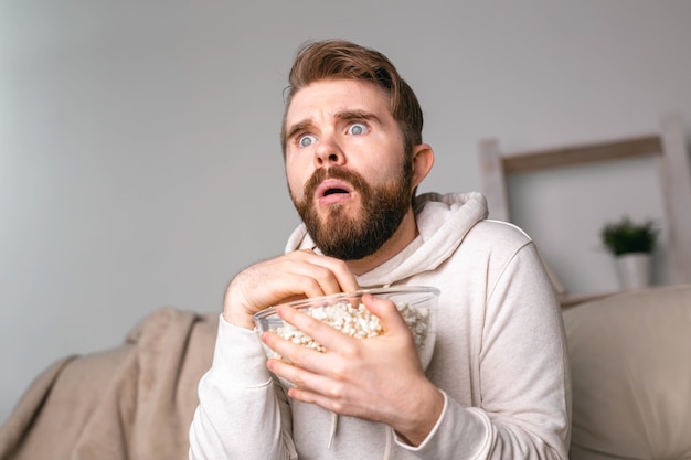 Photo portrait of guy watching tv series online online cinema and video streaming service concept