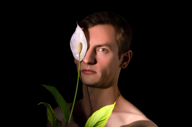 Portrait of a guy white flower on the background of the face