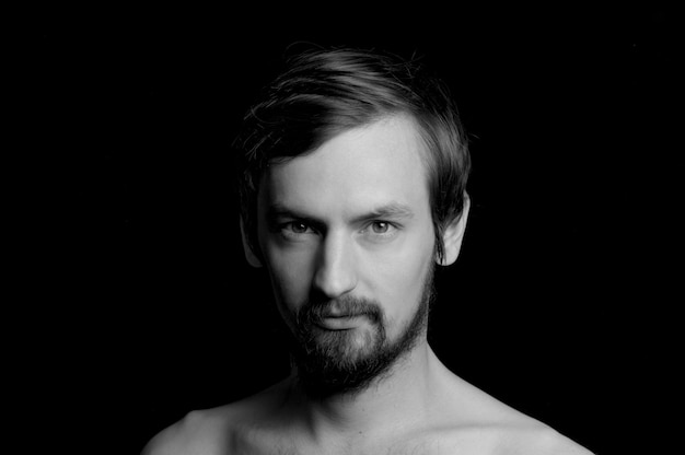 Portrait of a guy with a beard on a black background