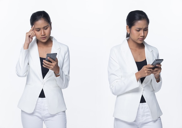 Portrait Half Body Snap Figure, Asian Business Woman Stand in White Formal proper Suit pants, studio lighting white background isolated, Lawyer Boss using smart phone bad news and stress serious issue