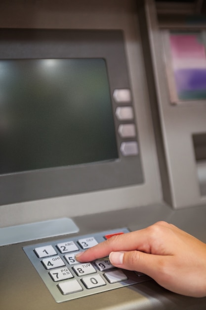 Portrait of a hand typing a PIN code