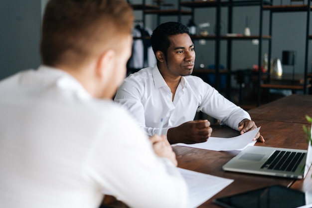 Portrait of handsome african american business man listening\
business idea increasing sales